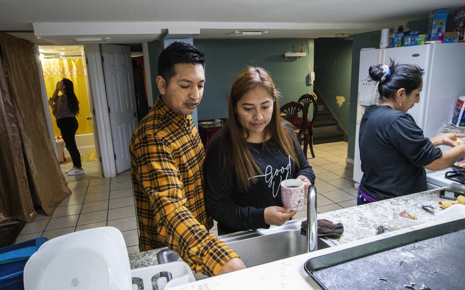 Ecuadorian migrant Klever Ortega, left, and his wife, Cristina Lema, prepare breakfast for their family, Saturday, March 3, 2023, in Spring Valley, N.Y. Ecuador — long known for remarkably low rates of crime, despite sitting in South America’s cocaine heartland — has been struggling economically, fighting higher violence and losing its people in record numbers. Like Ortega and Lema, many are headed to the U.S.