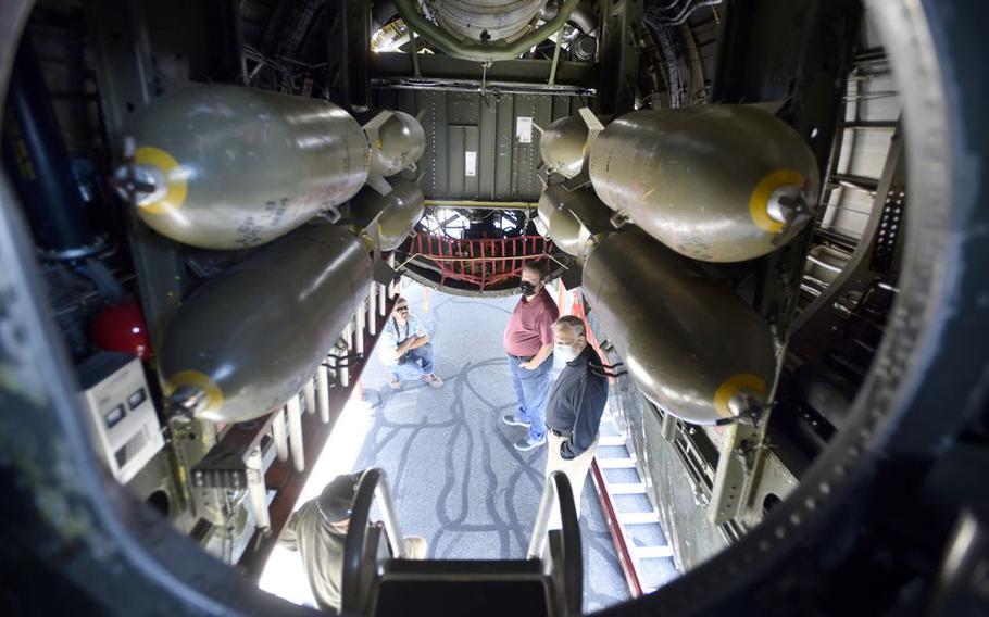 Visitors stand under the bomb bay doors of “Fifi,” a 1945 B-29 Superfortress.