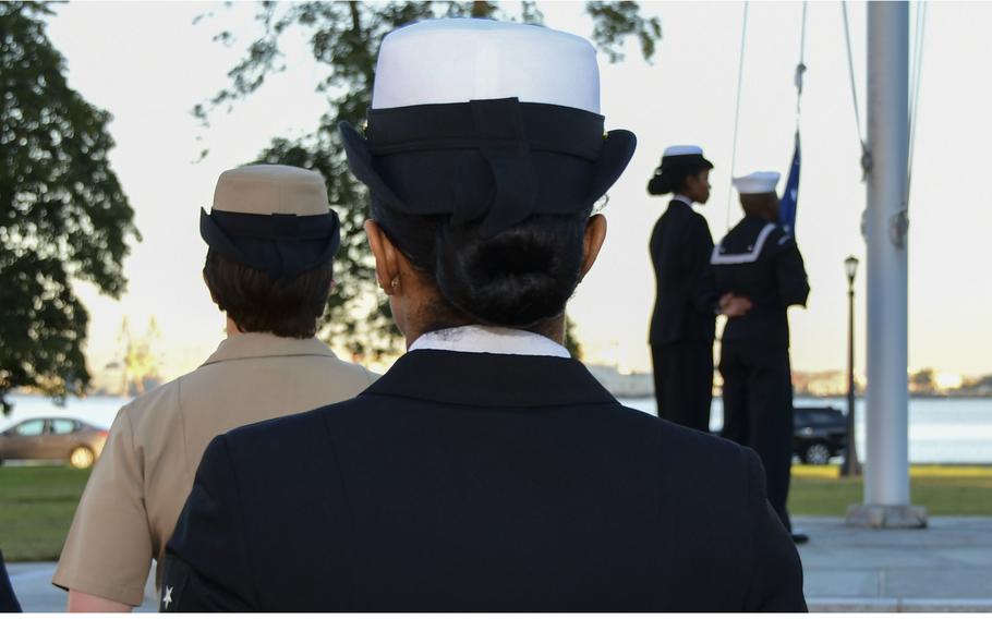 Members of Naval Medical Center Portsmouth, Va., observe morning colors in October 2018 before gathering for a group photo with their combination or “bucket” covers. 