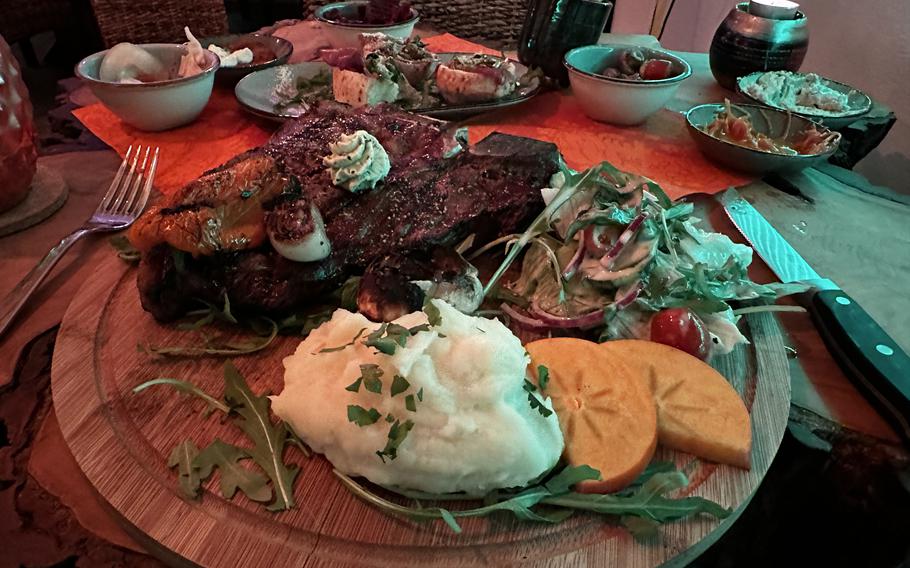 The dry-aged T-bone steak comes with mashed potatoes and a side salad at Casa do Brasil steakhouse in Vilseck, Germany. 