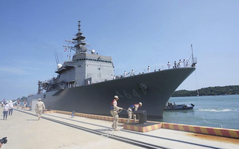 a Japanese warship docks at a naval base’s pier