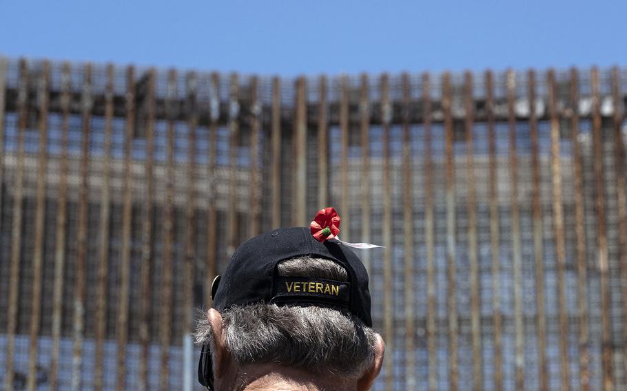 A veteran stands next to the border fence during the “Remembering our Fallen Exile Deported Veterans” event to commemorate the Memorial Day, at the US-Mexico border in Playas de Tijuana, Baja California state, Mexico, on May 29, 2022. 