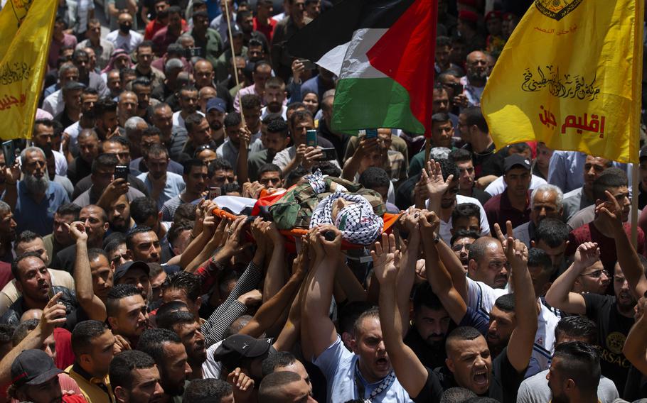 Palestinian mourners carry body of Palestinians security officer, Tayseer Issa, in the West Bank city of Jenin, Thursday, June 10, 2021. Israeli troops shot and killed three Palestinians, including two security officers, in a shootout that erupted in the West Bank town of Jenin during what appeared to be an Israeli arrest raid overnight, Palestinian officials said Thursday. (AP Photo/Majdi Mohammed)