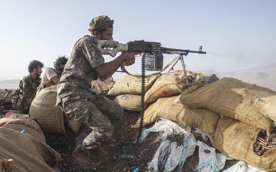 A Yemeni fighter backed by the Saudi-led coalition fires his weapon during clashes with Houthi rebels on the Kassara frontline near Marib, Yemen on June 20, 2021.
