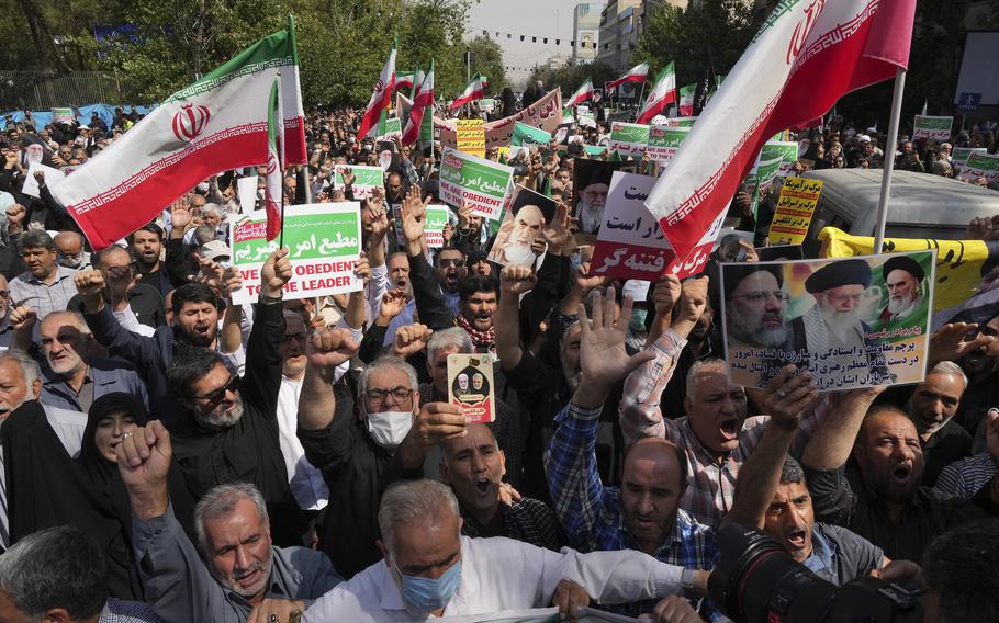 Iranian pro-government demonstrators attend a rally after their Friday prayers to condemn recent anti-government protests over the death of a young woman in police custody, in Tehran, Iran, Friday, Sept. 23, 2022. The crisis unfolding in Iran began as a public outpouring over the the death of Amini, a young woman from a northwestern Kurdish town who was arrested by the country’s morality police in Tehran last week for allegedly violating its strictly-enforced dress code. 