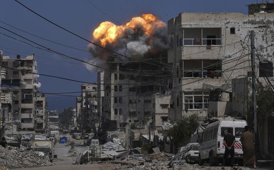 Smoke and flames erupt from an Israeli airstrike on a building.