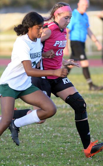 Freshmen Solares Solano of Kubasaki and Sydney Pontious of Kadena chase the ball during Wednesday's DODEA-Okinawa girls soccer match. The Panthers won 3-1.