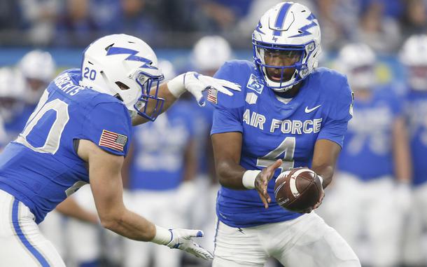 Air Force quarterback Haaziq Daniels hands off to running back Brad Roberts in the first half against  Army during an NCAA college football game in Arlington, Texas, Saturday, Nov. 6, 2021. 