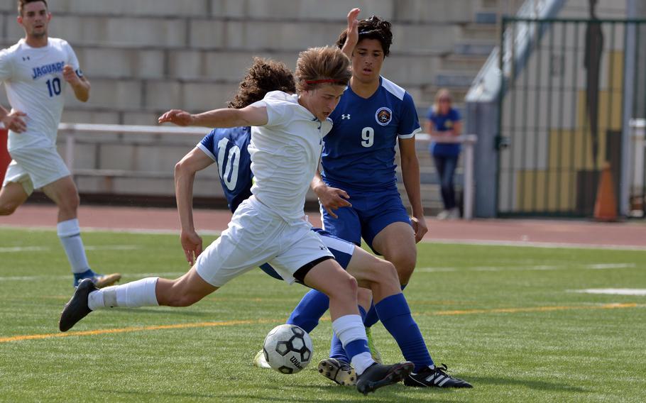 Sigonella’s Tim Garcia trie to get a shot off against William Gibbons and Matej Marinkovic, right, in the boys Division III final at the DODEA-Europe soccer championships in Kaiserslautern, Germany, Thursday, May 19, 2022. Garcia scored three goals in the Jaguars 5-0 victory.