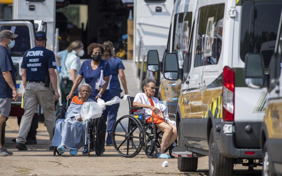 Paramedics evacuate people at a mass shelter Thursday, Sept. 2, 2021, in Independence, La. Multiple nursing home residents died after Hurricane Ida, but full details of their deaths are unknown because state health inspectors said Thursday that they were turned away from examining conditions at the facility to which they had been evacuated.