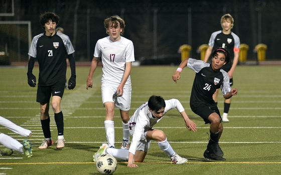 Stuttgart's Cristian McGinnis dribbles around Lakenheath defender James Idems during a March 21, 2025, match at Stuttgart High School in Böblingen, Germany.