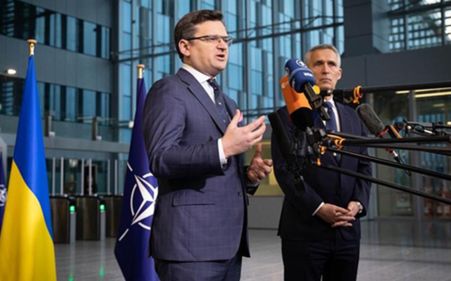 Ukrainian Foreign Minister Dmytro Kuleba speaks at NATO headquarters in Brussels on April 7, 2022, ahead of a meeting of officials from member and partner countries. Kuleba is flanked by NATO Secretary-General Jens Stoltenberg.