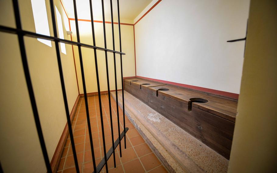 The reconstructed Roman latrine at Roman Villa Borg bathhouse features a row of simple wooden toilet seats and a sophisticated stone drainage system that once allowed waste to be flushed away.