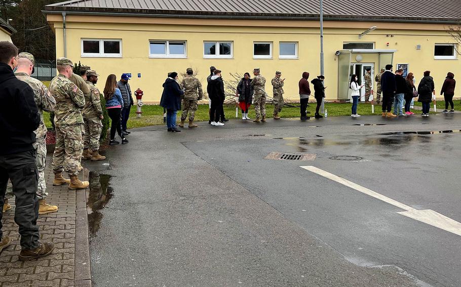 Walk-ins wait in line to get COVID-19 booster shots at the Dec. 8, 2021, vaccine rodeo at the Kleber Kaserne gym in Kaiserslautern, Germany. Demand for booster shots is tremendous, and appointments for them are being snapped up almost immediately.