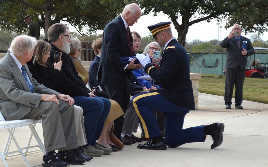Doug Smith accepts a folded flag during the funeral service of his uncle, Pfc. Clinton Edward Smith, at Fort Sam Houston National Cemetery in San Antonio, Texas, on Nov. 27, 2023. 