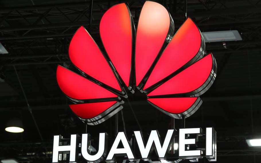 A Huawei illuminated logo hangs above the Huawei Technologies Co. stand on the opening day of the MWC Barcelona in Barcelona, Spain, on June 28, 2021. 