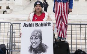 Witthoeft holds a sign with Babbitt’s photo.