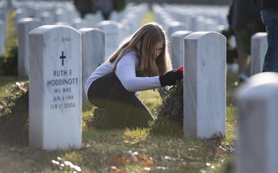 Volunteers participate in the 32nd Wreaths Across America Day In Section 64 of Arlington National Cemetery, Arlington, Va., Dec. 16, 2023.