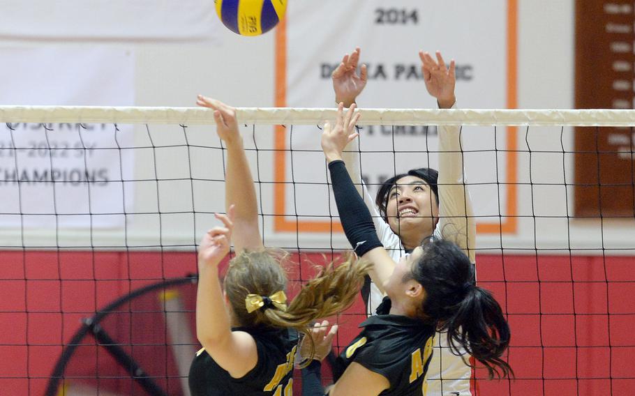 Nile C. Kinnick's Cierra San Nicolas battles at the net against American School In Japan's Lily Stone-Bourgeois and Sachika Nagaoka during Tuesday's Kanto Plain volleyball match. The Red Devils won in five sets.