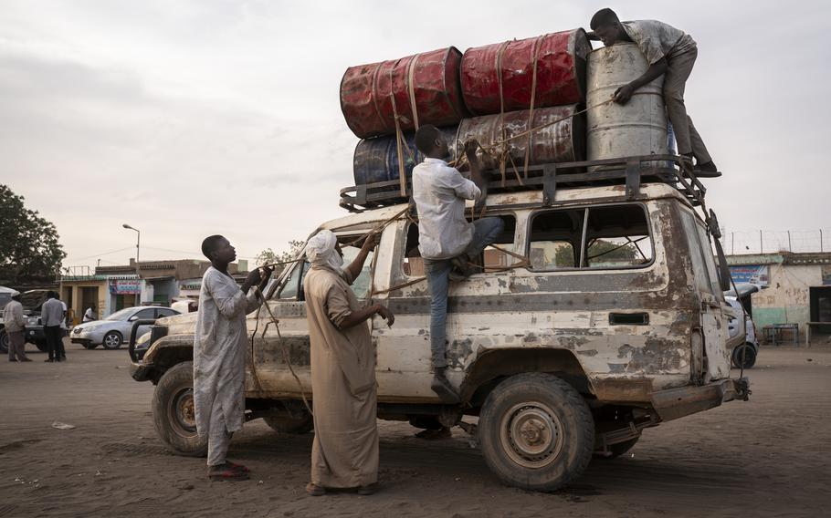 Men in El Geneina secure empty containers to a vehicle that will travel to Chad for the purchase of gasoline, which will then be sold at a premium in Darfur. No gas stations remain in service in El Geneina. They were all destroyed or looted in the conflict. Gas prices in West Darfur have nearly doubled since the start of the war.