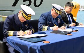Officials sign a trilateral letter of intent at Coast Guad Base Alameda, Calif., May 9, 2024, for the U.S., Japanese and South Korean coast guards to work together.