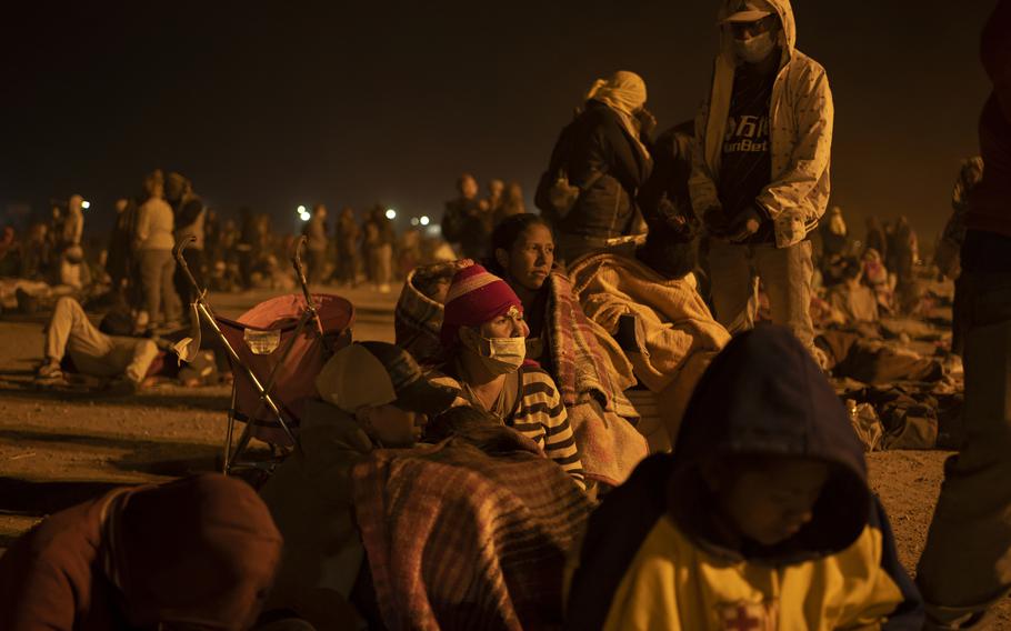 Migrants gather near the border wall amid heavy dust storms between the United States and Mexico in Ciudad Juárez, Mexico, on May 10, 2023. 