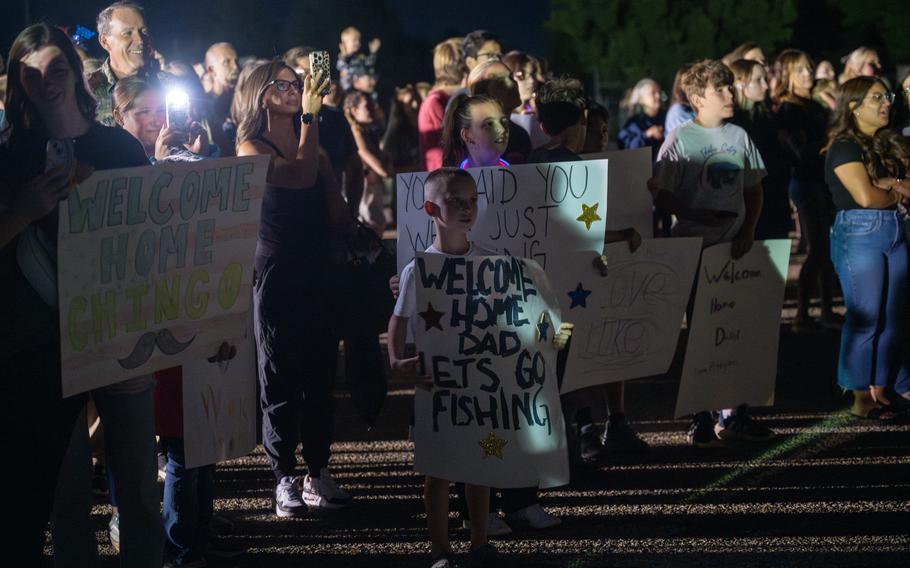 Families hold up posters 