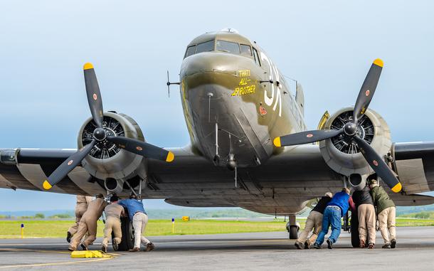 OXFORD, CT. 19 May 2019-051919 - Ground crews and willing volunteers help move the massive and heavy vintage World War II C-47, That's All Brother, into position as they and the other planes embark on their journey overseas to Normandy, France at Waterbury Oxford Airport in Oxford on Sunday. Bill Shettle Republican-American