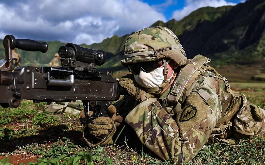 A soldier with the 25th Infantry Division looks down the sight of an M240B machine gun during a joint artillery mission at Makua Military Reservation, Hawaii, Aug. 11, 2020. 