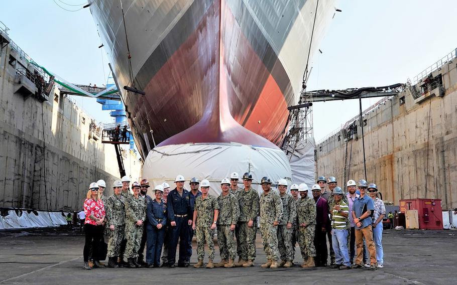 Adm. Samuel Paparo, commander of U.S. Pacific Fleet, poses Jan. 10, 2023, with sailors and personnel from Pearl Harbor Naval Shipyard and Intermediate Maintenance Facility, Hawaii, where the USS Michael Murphy is undergoing maintenance.