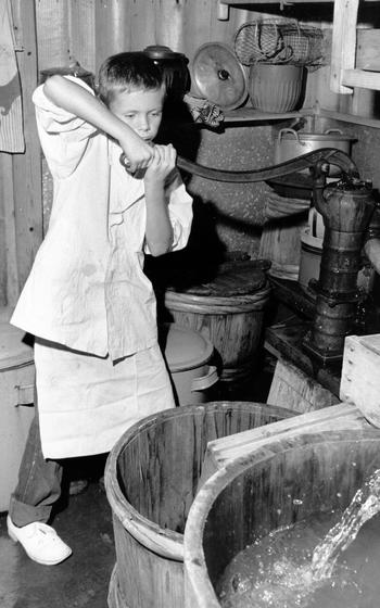 A child works a water pump