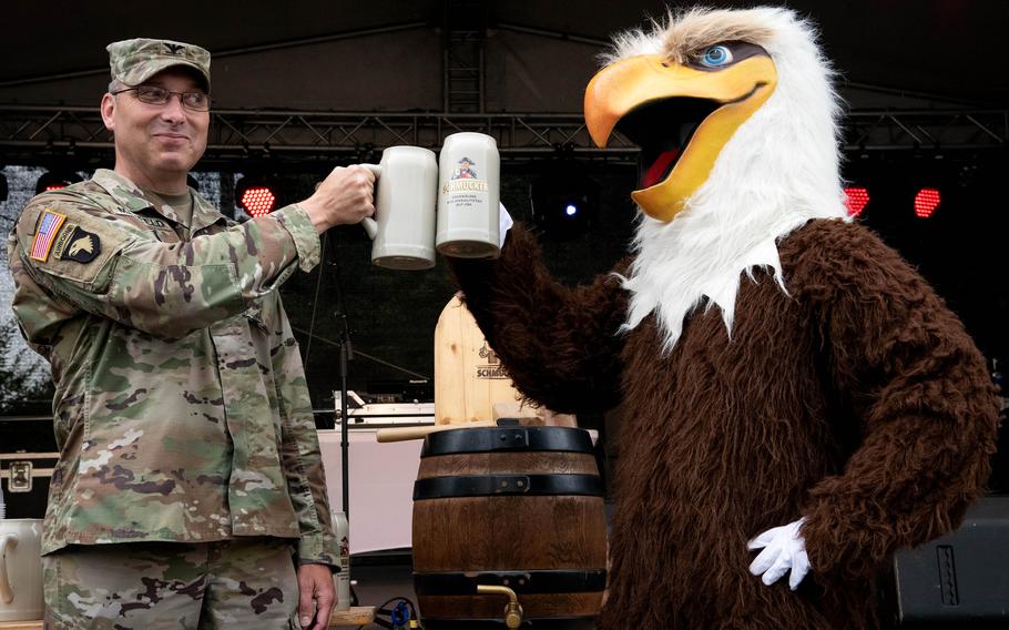 Wiesbaden garrison commander Col. David Mayfield toasts the opening of the German-American Friendship Festival at the Hainerberg housing area with the AFN mascot, June 29, 2023.