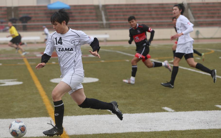 Zama's Sean Hinchey pushes the ball up field against E.J. King during Tuesday's Division II boys soccer match. The Cobras won 1-0.