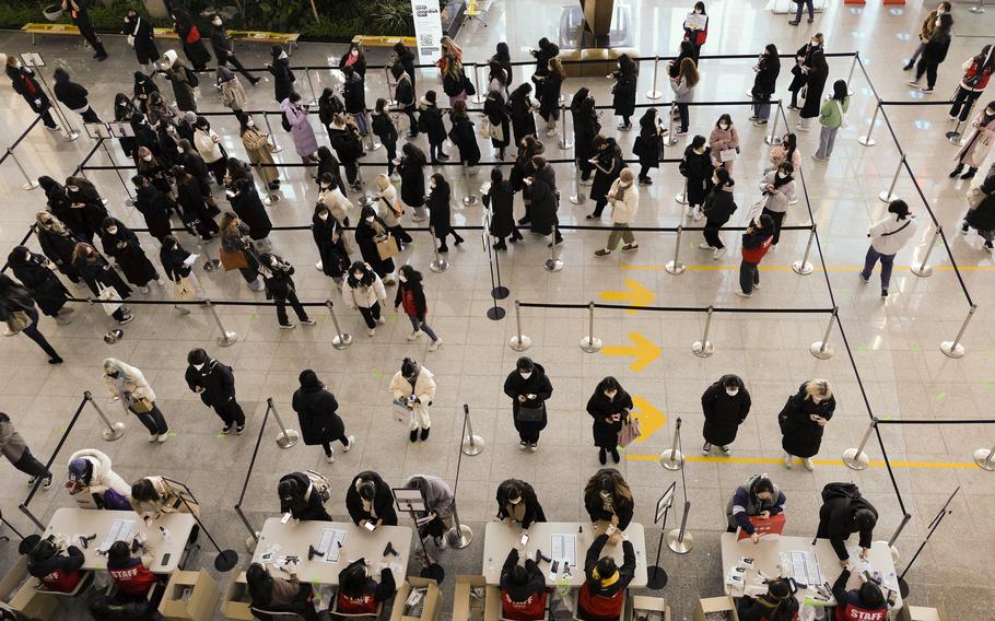 Concertgoers have their tickets and vaccination status checked before entering the concert venue in Goyang, South Korea, on New Year’s Eve. 