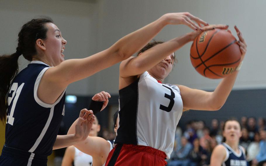 Black Forest Academy’s Caelyn Wilbanks and American Overseas School of Rome’s Nina Neroni fight for a rebound in a Division II semifinal at the DODEA-Europe basketball championships in Ramstein, Germany, Feb. 17, 2023. AOSR beat BFA 34-31 to advance to the championship game against Naples. 