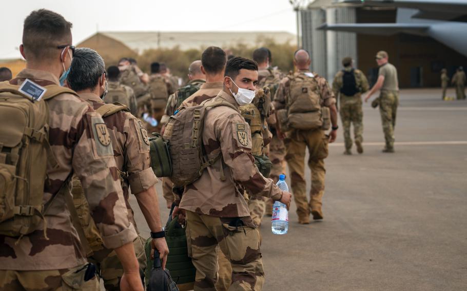 French Barkhane force soldiers who wrapped up a four-month tour of duty in the Sahel board a US Air Force C130 transport plane as they leave their base in Gao, Mali on Wednesday June 9, 2021.