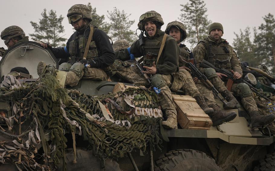 Ukrainian service members ride on an armored transporter driving through a Russian position overrun by Ukrainian forces outside Kyiv, Ukraine, on Thursday, March 31, 2022. The war is now shifting to the eastern region of Donbas.