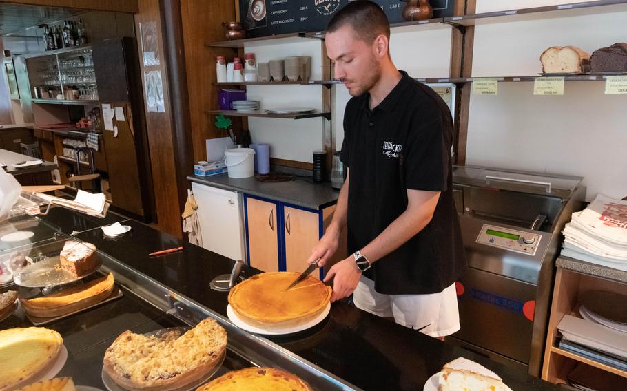 Paul Wildberger cuts a slice of cinnamon cream cake, or zimtrahmkuchen, at Cafe Baennjerrueck on June 27, 2023. 