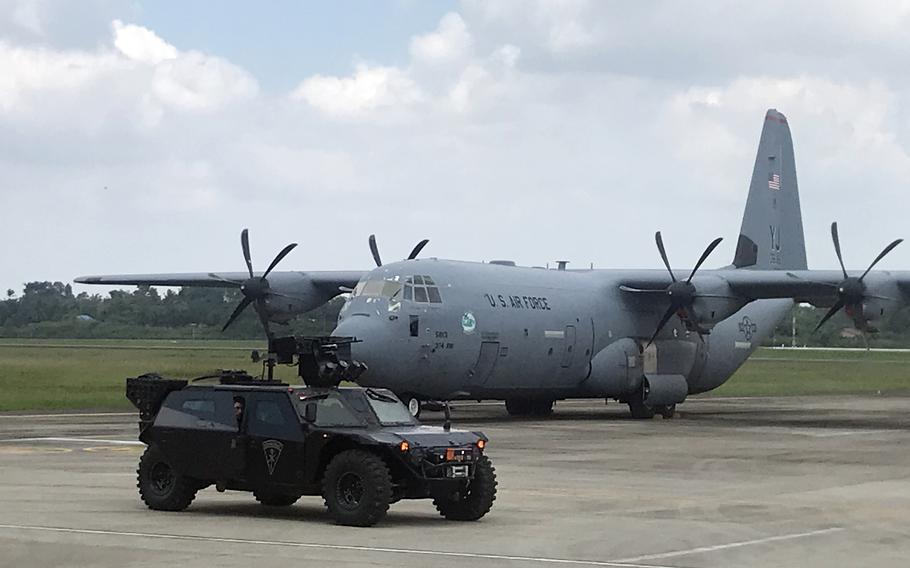 An Indonesian military vehicle passes a U.S. Air Force C-130J Super Hercules from the Japan-based 36th Airlift Squadron during Super Garuda Shield training at Palembang, Indonesia, Monday, Aug. 8, 2022.