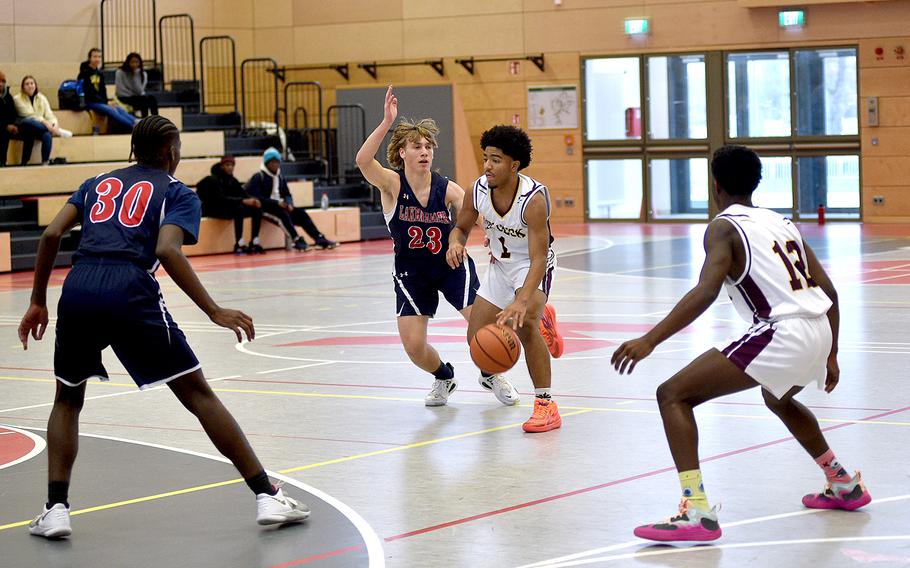 Vilseck’s Brandon Goins dribbles as Lakenheath’s Max Mittenzwey defends during Saturday’s matchup at Kaiserslautern High School in Kaiserslautern, Germany. Watching are Lakenheath’s Jerry Maroney III, left, and Vilseck’s Kendall Terrell.