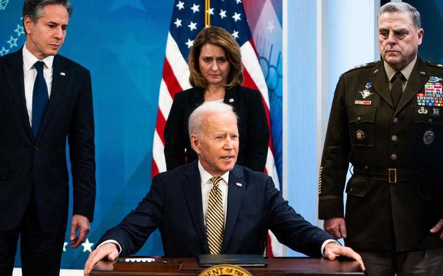 President Biden speaks to the news media on March 16. He is backed by, from left, Secretary of State Antony Blinken, Deputy Defense Secretary Kathleen Hicks and Gen. Mark A. Milley, chairman of the Joint Chiefs of Staff.