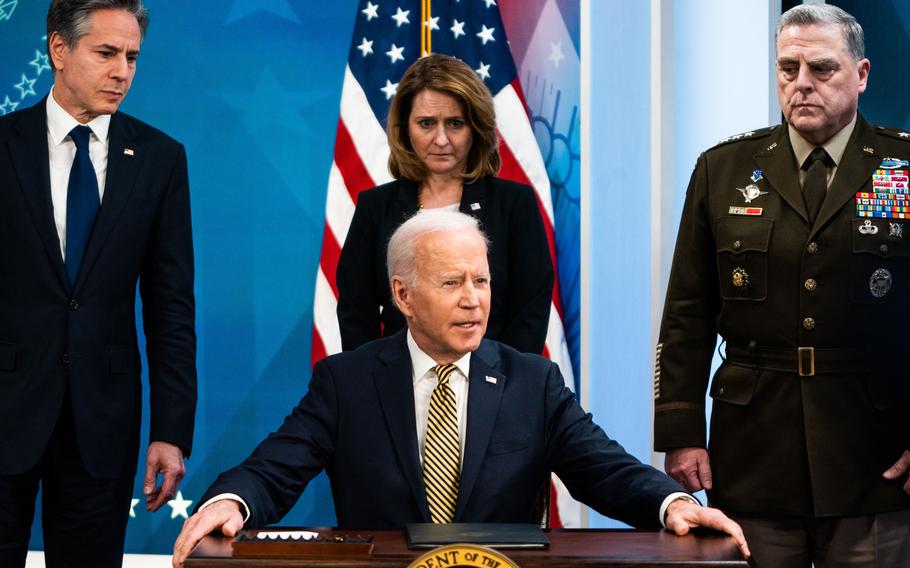 President Biden speaks to the news media on March 16. He is backed by, from left, Secretary of State Antony Blinken, Deputy Defense Secretary Kathleen Hicks and Gen. Mark A. Milley, chairman of the Joint Chiefs of Staff.