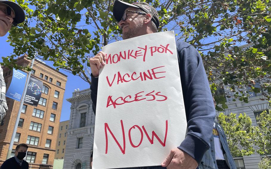 FILE - A man holds a sign urging increased access to the monkeypox vaccine during a protest in San Francisco, July 18, 2022.