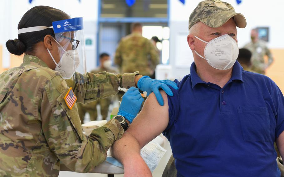 Joe Gallagher, a U.S. Army veteran, receives a coronavirus vaccination at the 7th Army Training Command’s Rose Barracks in Vilseck, Germany, on May 3, 2021. Top Army leaders are directing service officials to pause enforcement of President Joe Biden’s coronavirus vaccination mandate for civilian workers after a federal judge on Friday ordered the U.S. government to temporarily halt the policy.