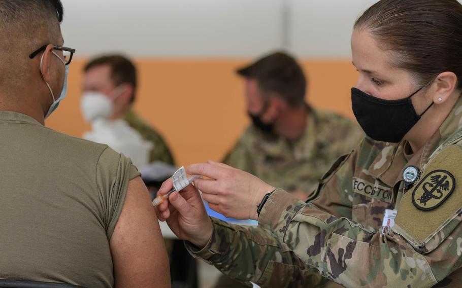Lt. Col. Sarah Eccleston, right, clinic commander of U.S. Army Health Clinic Vilseck, administers a COVID-19 vaccine at the 7th Army Training Command’s Rose Barracks, Vilseck, Germany, in May 2021.