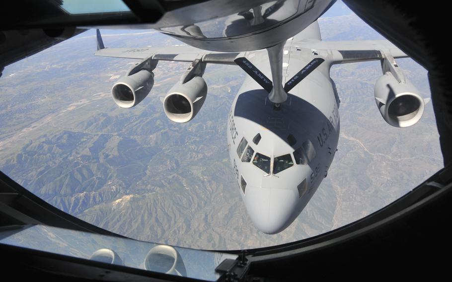 A U.S. Air Force C-17 Globemaster III from the 729th Airlift Squadron, and a KC-15 Stratotanker from the 336th Air Refueling Squadron, perform an aerial refueling mission as part of a civilian media flight during Air Fest 2016, March Air Reserve Base, Calif., April 15, 2016. 