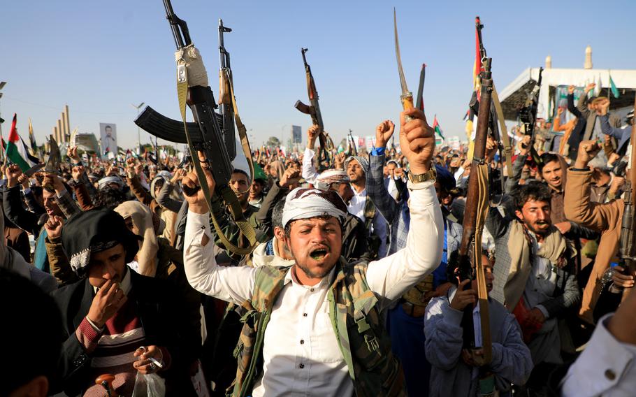 Houthi fighters brandish their weapons during a protest following airstrikes by U.S. and British forces in the capital Sanaa on Jan. 12, 2024, amid the ongoing battles between Israel and the militant Hamas group in Gaza. 
