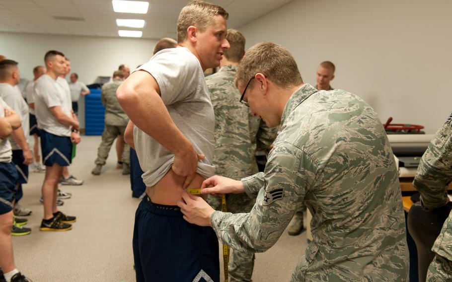 Airmen perform a waist measurement at Gowen Field, Idaho, in 2015. The service on Monday announced a new requirement for waist-to-height ratios that calculate body composition independent of the annual fitness fitness test requirement.