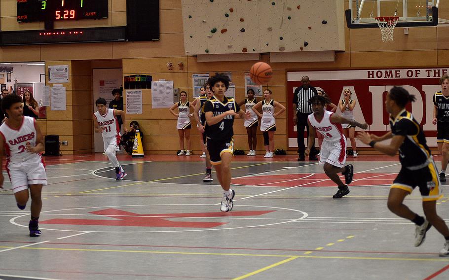 Stuttgart's Ismael Anglada-Paz passes the ball to teammate Tyler Jackson, front right, during Friday evening's game at Kaiserslautern High School in Kaiserslautern, Germany. The Raiders' Tyriq Etan, bottom left; Jayden Dayao, back left; and Akori Ford, third from right, get back on defense. The Panthers' Jacob Schudel, back right, follows the action.