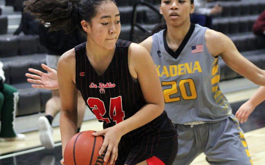 Kinnick's Kotone Turner looks for room against Kadena's Ayanna Levi during Tuesday's Panthers' 32-24 win over the Red Devils.